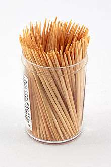 Photograph of a container full of wooden toothpicks.